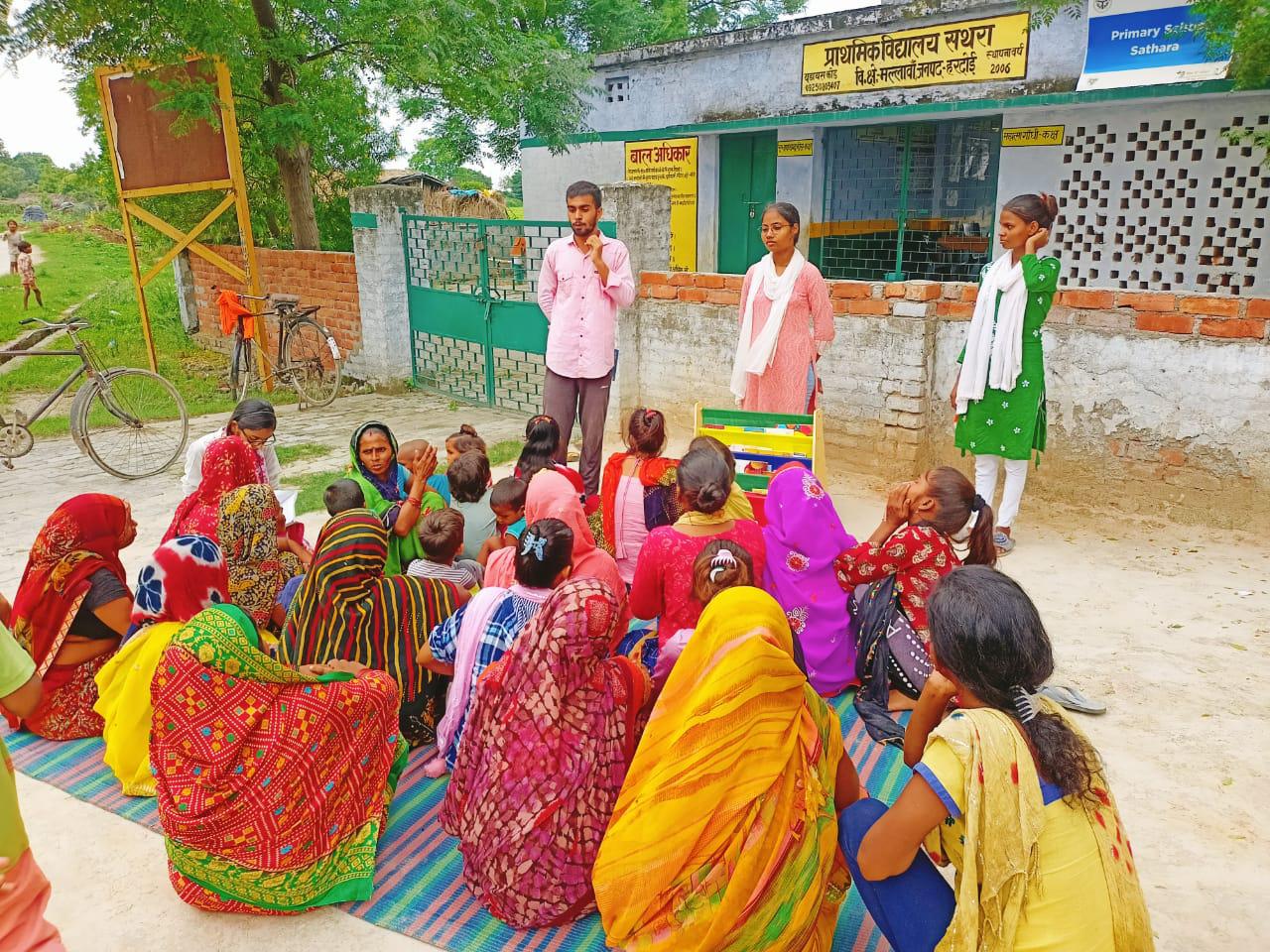 Adults and children gathered outdoors in a rural community